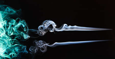 abstract colourful smoke lines isolated on blackの写真素材