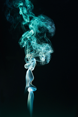 green smoke cloud on black backgroundの写真素材