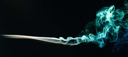 smoke colour swirles isolated on black backgroundの写真素材