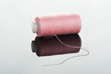 one pink thread lay horizontal on white backgroundの写真素材