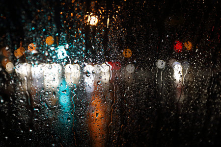 Abstract blurred rain background, view through wet car window