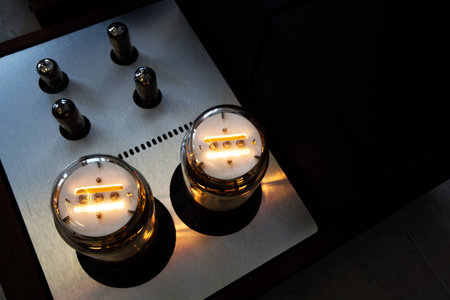 Vintage retro music amplifier with glass lamps light on