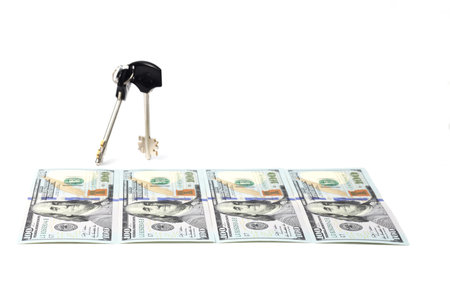 Isolated Key and dollar bills  on white background