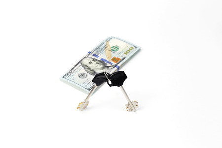 Isolated Key and dollar bills on white backgroundの写真素材
