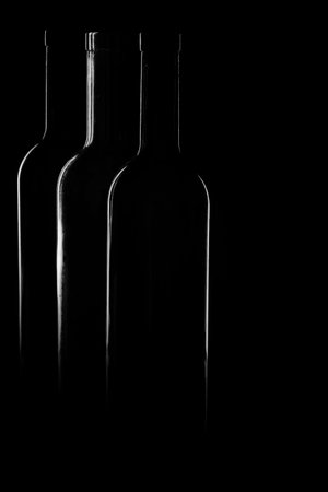 Contours of vine bottles on the black backgroundの写真素材