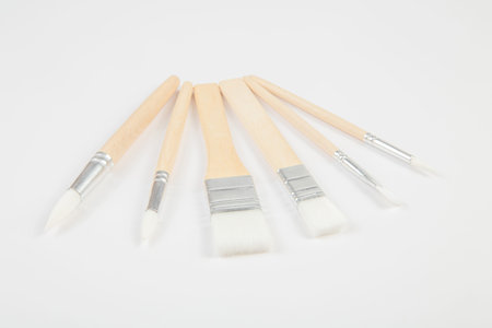 White paintbrushes with wooden handle isolated clear background