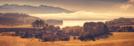 Summer mountain landscape with village next ro riverの写真素材