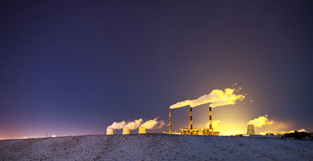 Power plant at night with thick smoke under the starsの写真素材