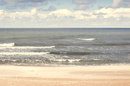 sea coast with big waves and sandの写真素材