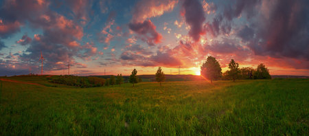 Wind turbines at the sunset with big green valleyの写真素材