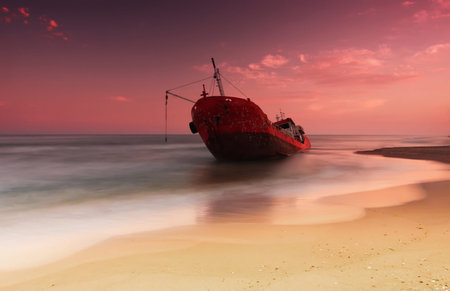Ship after wreck on the coast with smooth waterの写真素材