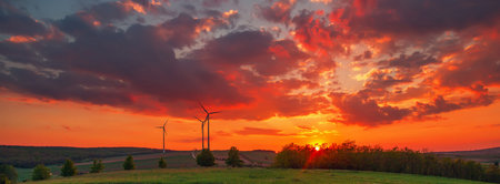 Wind turbines at the sunset orange clouds panorama