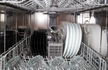 Dishes after cleaning in a modern dishwasher machine