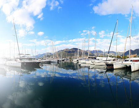 White yachts in a blue sea water on a sunny dayの写真素材