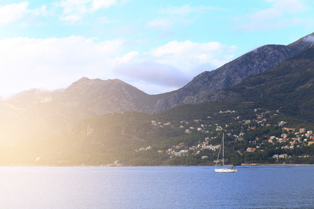 White sailing boat in bay on a sunny dayの写真素材
