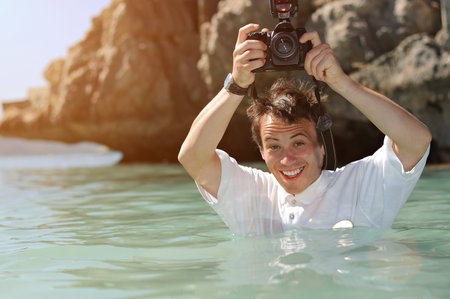 photographer hold camera in caribbean sea half body