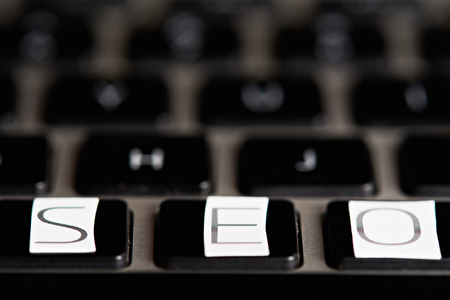 SEO word on keyboard on blurred backgroundの写真素材