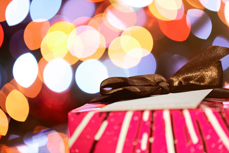 colorfull christmas gift box with bow on glitter background