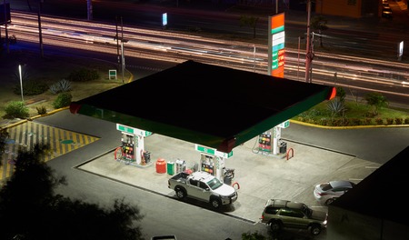 Gas station at night city with blurred car lightsの写真素材