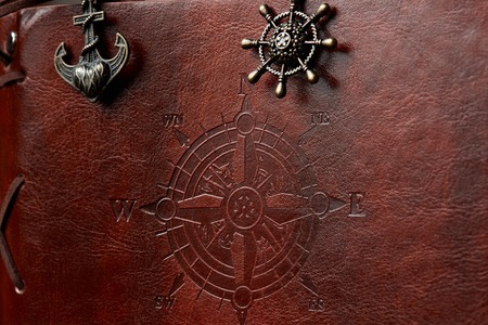 Closeup of brown leather book  ship cover with compassの写真素材