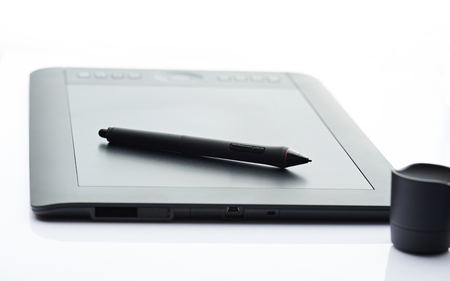 Digital graphic tablet isolated on white background. Closeup of drawing deviceの写真素材