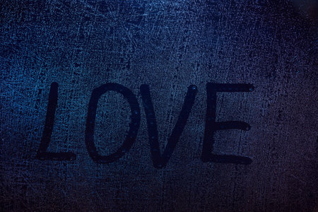 Love word concept draw on frozen window texture. Love word on wet glass backgroundの写真素材
