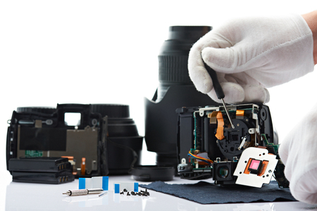 Repairing broken modern DSLR camera isolated on white backgroundの写真素材
