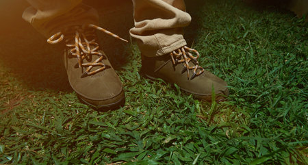 Modern hike shoes closeup stand on green grass. Pair of hiking shoes