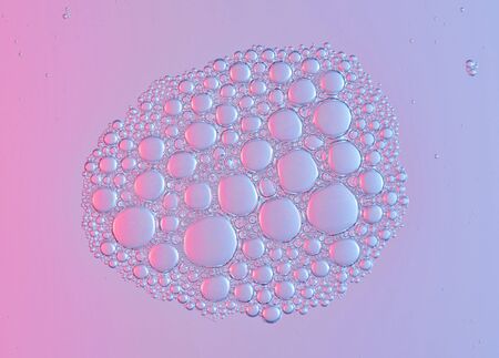 Group of foam bubbles on clear pink water surface. Abstract air bubble backgroundの写真素材