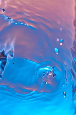 Pattern water surface with splash. Water drop fall on rippled surfaceの写真素材