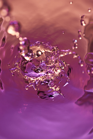 Big water splash above view. Purple liquid abstract wallpaper backgroundの写真素材