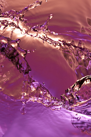 Macro of colorful water splash. Abstract water splash background wallpaperの写真素材