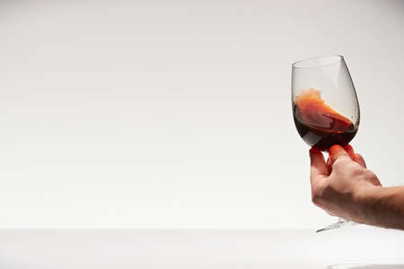 Red wine celebration background. Hand make toast with red wine close-upの写真素材