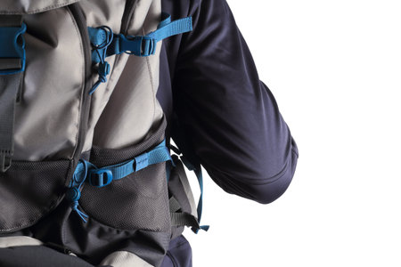 Close-up of backpack on man back isolated on white background. Traveler with blue backpack closeup.の写真素材