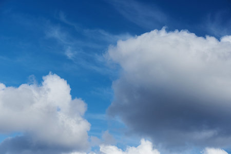 Big clouds on blue sky background. Close up of cloudscape at sunny day time