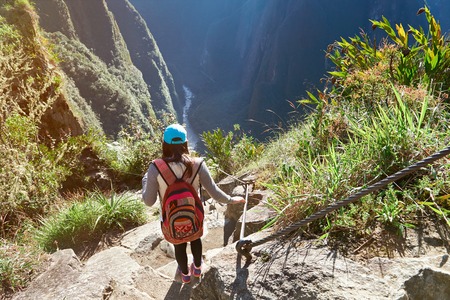 Woman in nature adventure walk in mountain landscape. Girl doing trekking in Machu Picchu pathの写真素材