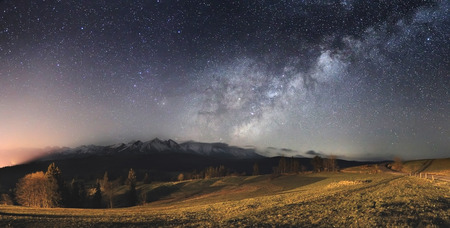 Starry sky over mountains. Bright milky way above mountains. Gorgeous night landscape.の写真素材