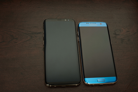 New york, USA - June 13, 2017: Samsung latests smartphones comparation laying on dark wooden tableのeditorial素材