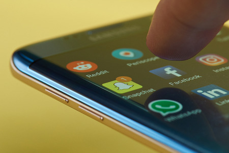 New york, USA - June 23, 2017: Run facebook application on smartphone. Start facebook application around other social network appsのeditorial素材