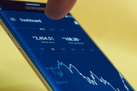 New york, USA - June 27, 2017: Mobile application for checking bitcoin price. Smartphone screen with bitcoin exchange rateのeditorial素材