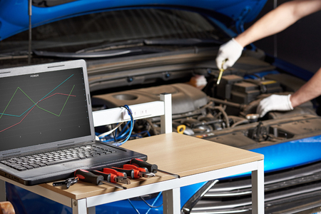 Equipment for electirc car testing with laptop. Diagnostic errors of modern car closeup.の写真素材
