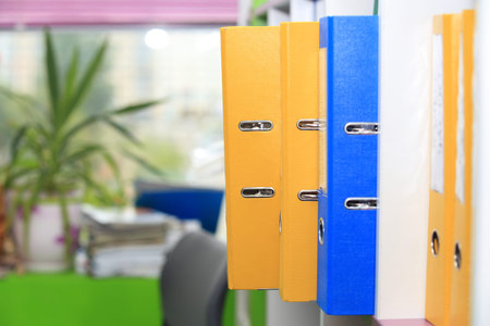 Folders in office. Folders on office window background.