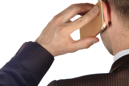 Businessman talking on the phone isolated on white background. Man use smartphone from back close-up.の写真素材