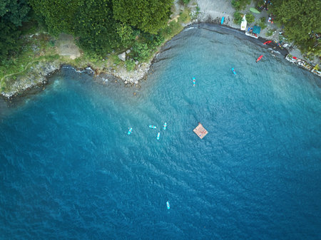 Group of kayaks in lagoon view from above in blue waterの写真素材