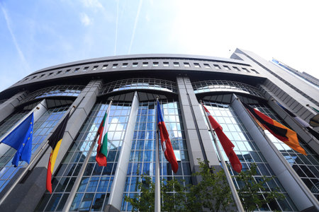 Brussels, Belgium - July 17, 2017: Flags on European Parliament building background. Flags of EU countries opposite facade of European Parliament building.のeditorial素材