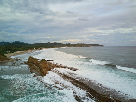 Magnific rock in Nicaragua beach aerial view. Ocean coastline