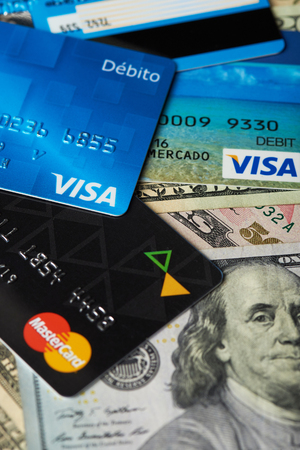 New york, USA - August 24, 2017:Close-up of visa and master card on dollar bill background. Finance banking themeのeditorial素材