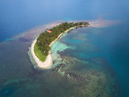 One small island in blue sea water aerial drone view