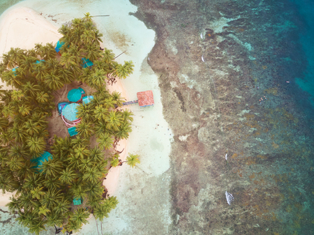 Small tropical island above view on sunny light dayの写真素材