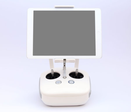 Remote controller of drone with white tablet.